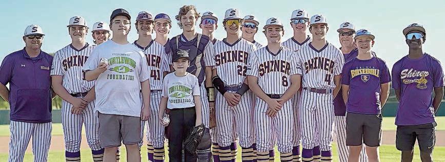 John and Cannon with the Shiner baseball team when the program hosted its Turtle Wing Game on April 2