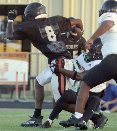 Da’Terrion Houston drags a Wildcat tackler to finish off a 20-yard reception. Sticker Photo By Darrell Vyvjala