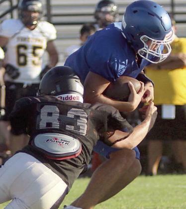 Brycen Schramek brings down a Bartlett running back behind the line of scrimmage. Sticker Photo By Darrell Vyvjala
