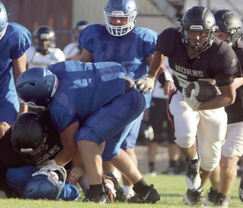 Nicolas Lopez (right) scoops up a Bartlett fumble after a teammate buries the Bulldog ball carrier. Sticker Photo By Darrell Vyvjala