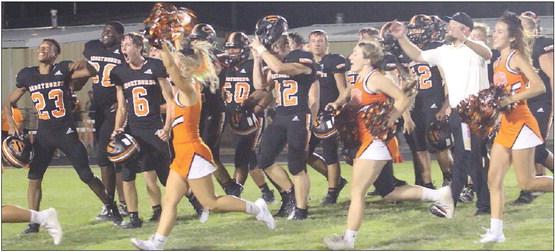 Shorthorn players, along with cheerleaders, celebrate their victory. Sticker Photo By Layne Vyvjala