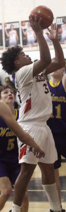 Jayvan Luhrs goes up for a score under the basket in the fourth quarter against Weimar. Sticker Photo By Darrell Vyvjala