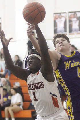 Rodney H Walton fights for a rebound in the second half Friday. Sticker Photo By Darrell Vyvjala