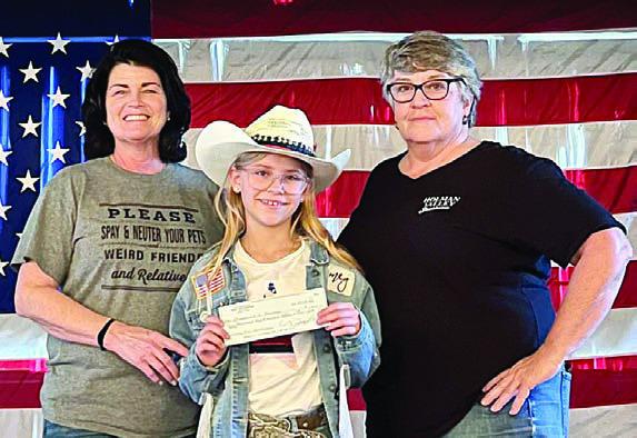 Marley Vasek (center) presents a donation to the Gardenia E. Janssen Animal Shelter in Fayette County, represented by Teresa Stanley-Brown (left). Also shown is Wendee Galleymore (right), Holman Valley Steakhouse owner.