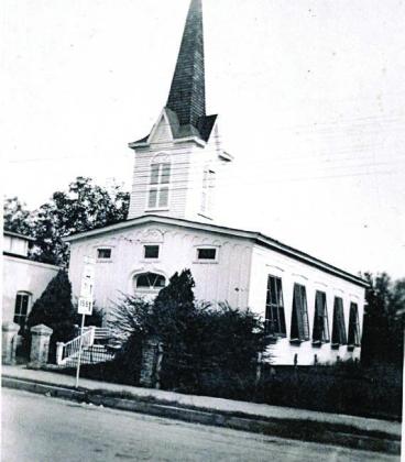 Union Church with the shutters of five large widows on the west side tilted open for air circulation. There are also three small windows across the upper front. Photo Courtesy of First Presbyterian Church