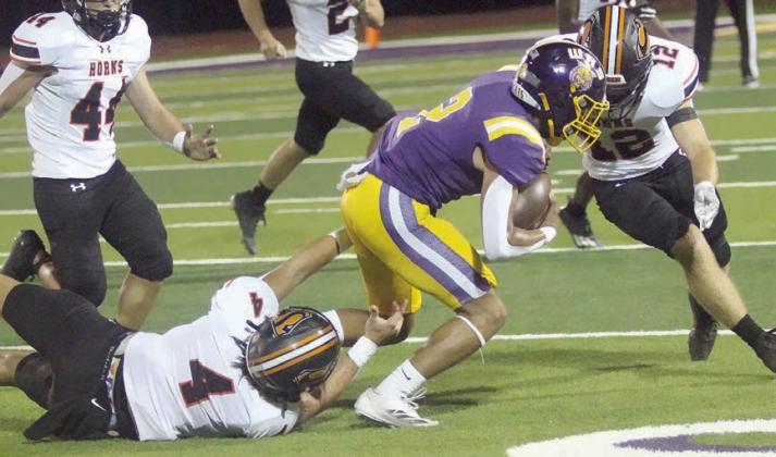 Jayse Janda (No. 4) and Reid Janda (No. 12) combine to drop Jerron Fisher for a loss of 2 midway through the first quarter. Sticker Photo By Layne Vyvjala