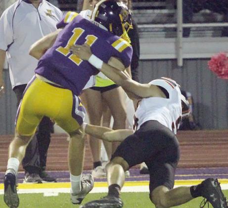 Adin Beyer chases down Huxton Kloesel on punt coverage in the first quarter. Sticker Photo By Layne Vyvjala