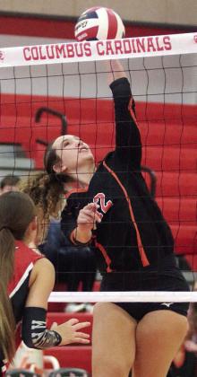 Grace Schramek connects on a spike for a point in the first match against West in the Columbus tourney. Sticker Photo By Darrell Vyvjala