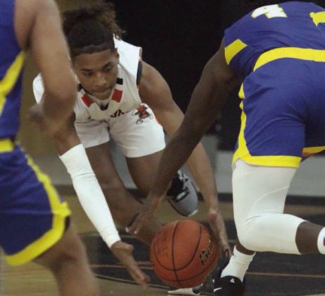 Byron Johnson takes the ball away from a Hornet in the first quarter. Sticker Photo By Darrell Vyvjala