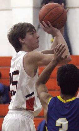 Zane Brenek goes up for a jump shot in the lane against Louise. Sticker Photo By Darrell Vyvjala