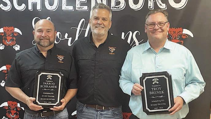 Outgoing trustees recognized at Monday night’s school board meeting by Superintendent Lee Hafley (center) were Jarrod Schramek (left), 10 years, and Troy Brenek (right), three years. Sticker Photo By Darrell Vyvjala