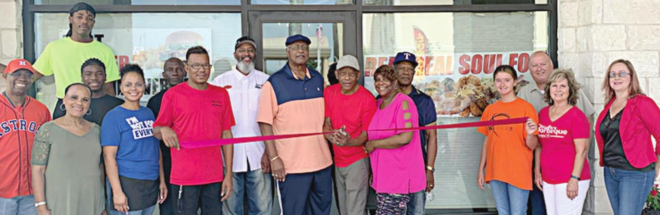 Real Deal Soul Food cuts ribbon