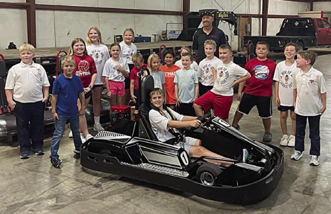 St. Rose Science Club members who visited American Kart Manufacturing (formerly Shaller Enjuneering) included (front, in go-kart) Levi Johnson, (standing, from left) Wyatt Smrkovsky, Hagan Holub, Emma McCourt, Brenley Berger, Addison Johnson, Zoey Krenek, Miles Krenek, Adriana Leihardt, Rebeca Camacho, Claire McCourt, Cason Hale, Brennen Berger, Braydon Rainosek, Bentley Bubela, Brody Lewis and Hudson Novick. Standing behind the group is Greg Vrana, general manager at the facility.
