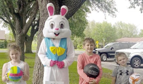 The Easter Bunny poses with three of the children who attended.