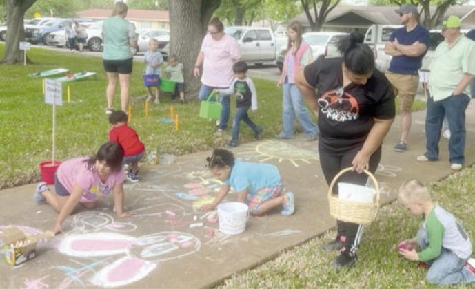 DRAWING ON THE SIDEWALK with chalk was one of the activities that children enjoyed.