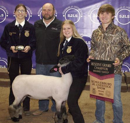 RESERVE CHAMPION MARKET SHEEP – Exhibitor: Haley Schramek (second from right). Sales price: $5,800. Sticker Photo By Darrell Vyvjala
