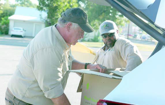 Un loading documents for shredding at last year’s Community Shred Day are FEC’s Larry Sulak and Macy Scott.