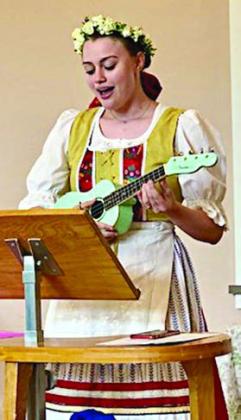 Fayette County CHS Queen Madelyn Karstedt playing the ukulele and singing a Czech song.