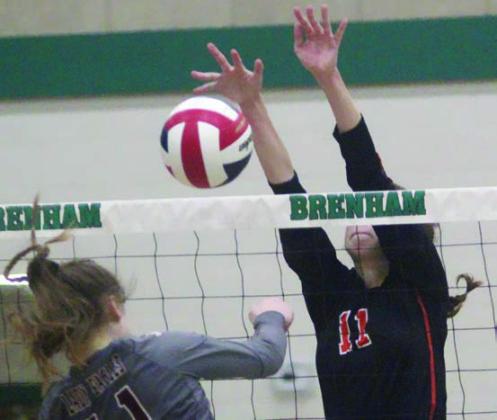 Meredith Magliolo gets a big block to tie the score at 12-12 in the fifth set against Johnson City. Sticker Photo By Darrell Vyvjala