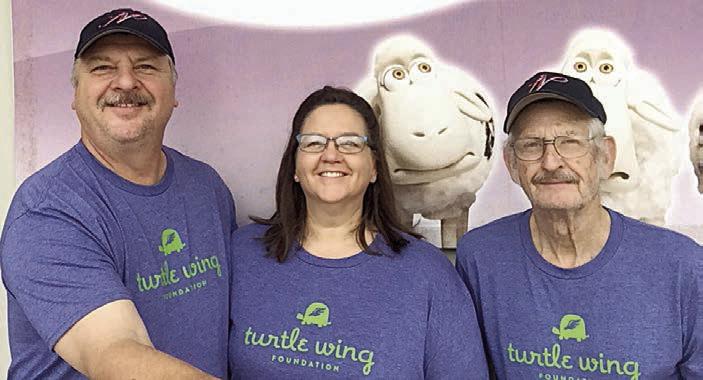 Bruce and JoAnn Lebeda (left) pose for a promotional photo in 2018 with their longtime service manager Billy Beiersdorfer, who passed away a few years later.
