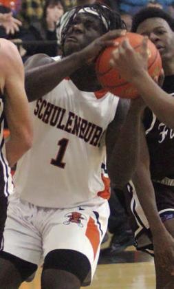 Rodney H Walton drives past Bulldog defenders in the first quarter. Sticker Photo By Darrell Vyvjala
