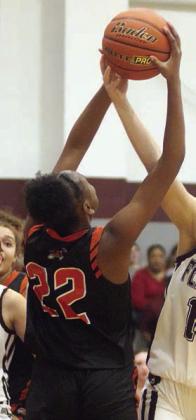 Jashiya Jackson grabs a rebound in the fourth quarter last Tuesday. Sticker Photo By Darrell Vyvjala