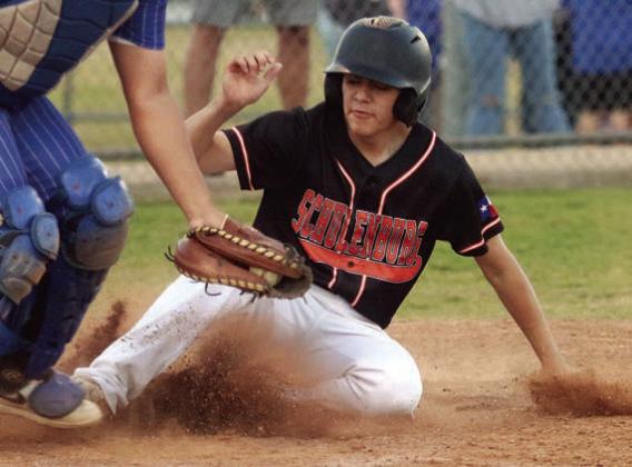 Courtesy runner Victor Mandujano slides home with a run in the first inning last Tuesday. Sticker Photo By Darrell Vyvjala