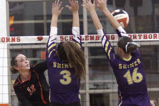 Grace Schramek goes cross-court to get a spike past a pair of Lady Comanche blockers in game four. Sticker Photo By Darrell Vyvjala