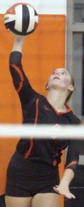 Avery Helms serves an ace late in the fourth set against Shiner. Sticker Photo By Darrell Vyvjala