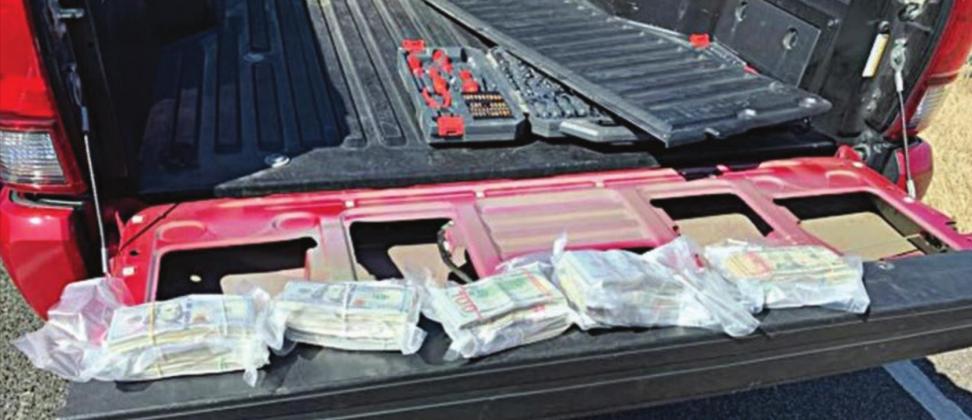 U.S. CURRENCY TOTALING $75,775 that was found concealed in the tailgate of a pickup is shown above.