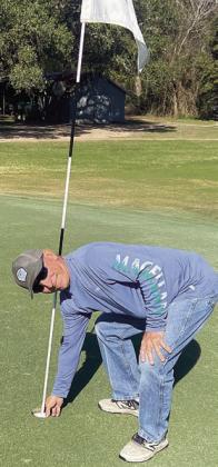Keith Hansen of Schulenburg retrieves his ball from the cup after recording a hole-in-one on Wednesday, Jan. 1 at Weimar Golf Course. His second lifetime ace came on the 140-yard, par-3 No. 9 hole using an eight iron. Witnesses were Mike Vacek and Joe Rawlinson.
