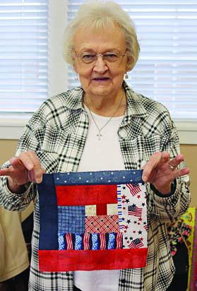 Displaying a beautiful Quilt of Valor block is Bobbie Elliott.