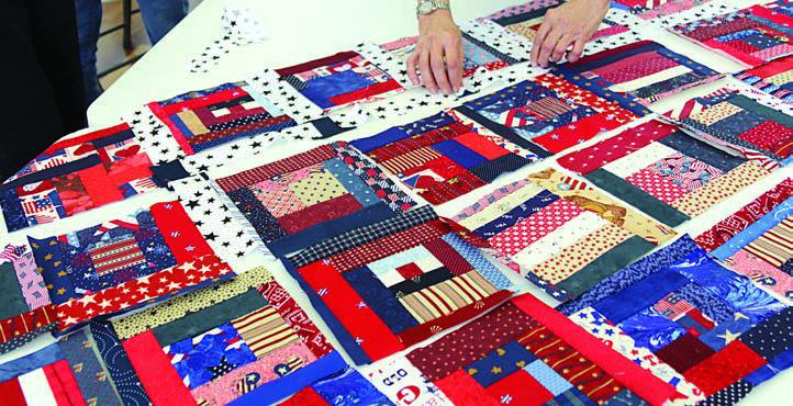 Work on piecing the Quilt of Valor blocks progresses at the Colorado Valley Quilt Guild workshop.