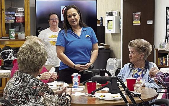 Lunch-and-learn speakers on Monday, Nov. 6 were Christy Bohuslav (standing behind table, in front) and Patti Sappington (standing behind table, in back), who discussed breathing and health.