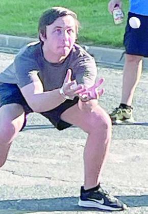 Luke Hollas sets his sights on the winning catch in the egg toss. Sticker Photo By Darrell Vyvjala