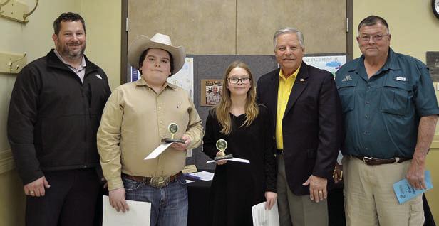 ESSAY CONTEST winners in the age 13 and under division were Rilan Karisch (second from left), a home-schooled student, and Danica Steakley (third from left) of Round Top-Carmine ISD. Presenters were Chris Kaspar (left) of Round Top State Bank, Gene Kruppa (second from right) of Colorado Valley Communications and Roy Wied (right) of Carmine State Bank.