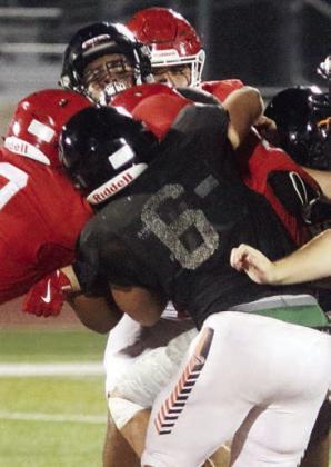 Ian Reeves (No. 6) and Jayvan Luhrs, two returners for 2025, team up to bring down a Cardinal runner. Sticker Photo By Darrell Vyvjala