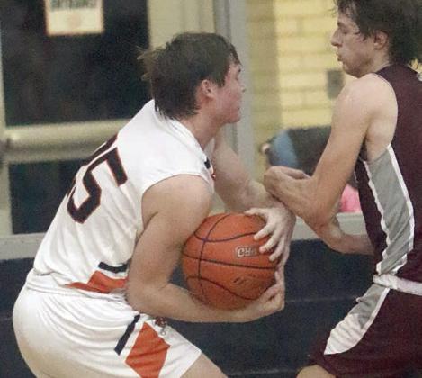 Owen Brenek takes the ball away from a Bulldog after the two battled for a rebound in the second half Friday. Sticker Photo By Darrell Vyvjala