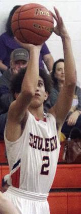 Denver Carr makes a jump shot in the first quarter against Shiner. Sticker Photo By Darrell Vyvjala