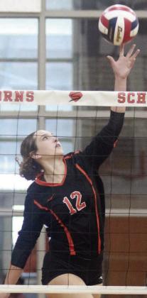 Grace Schramek tips the ball over for a point in the second set last Tuesday. Sticker Photo By Darrell Vyvjala