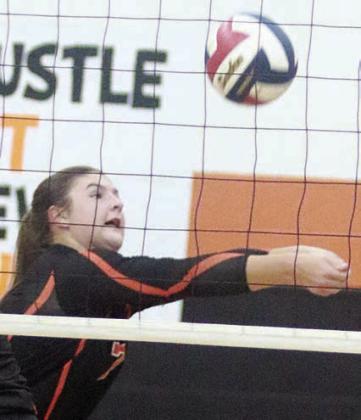 Landry Zapalac saves a ball near the net in the first set on Sept. 23. Sticker Photo By Darrell Vyvjala