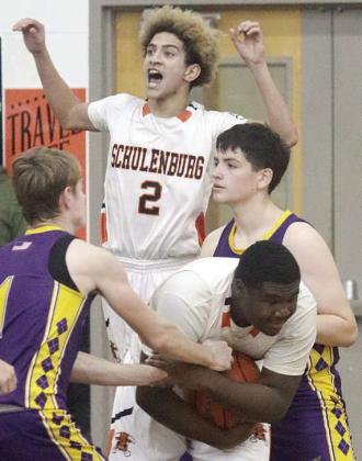 Denver Carr celebrates as Tavondrick Ellison secures the defensive rebound to seal the Horns’ win over Weimar. Sticker Photo By Darrell Vyvjala