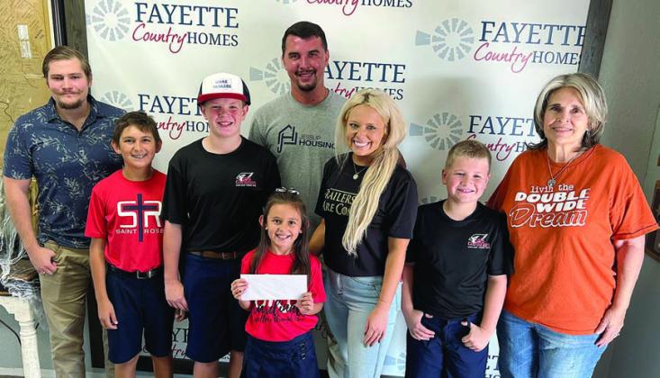 Representat ives of Fayette Country Homes and Adamek Rentals, shown with St. Rose students, are (from left) Dalton Manning, Dylan Zweschper-SRS, Bo Brossmann-SRS, Emma Zweschper-SRS, Dalton Friedrich, Hillary Adamek, Brody Brossmann-SRS and Sonjia Biddle.