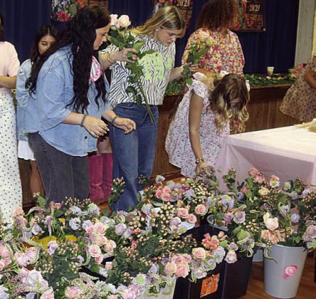Schulenburg FFA students prepare the containers for the afternoon competition during its first Petal Revival. Sticker Photo By Darrell Vyvjala