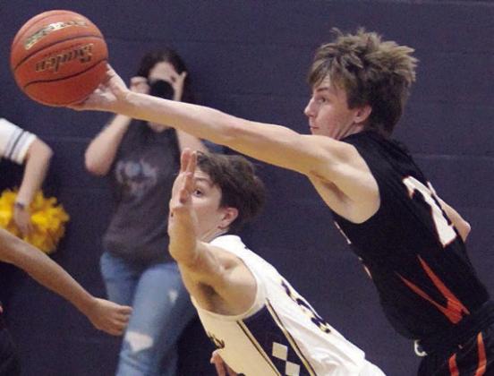 Zane Brenek deflects a Wildcat pass for a steal in the third quarter. Sticker Photo By Darrell Vyvjala