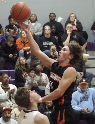 Jayse Janda scores over a Weimar defender on a third-quarter drive. Sticker Photo By Darrell Vyvjala