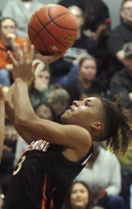 Byron Johnson goes to the hoop in the third quarter for two of his 12 points last Tuesday. Sticker Photo By Darrell Vyvjala