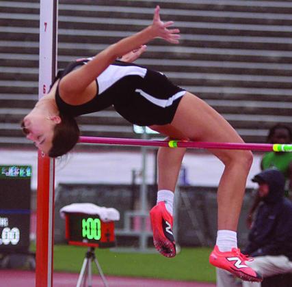 Meredith Magliolo gets over the bar at 5-feet, 4-inches at the state meet last Friday on her third attempt. Sticker Photo By Darrell Vyvjala