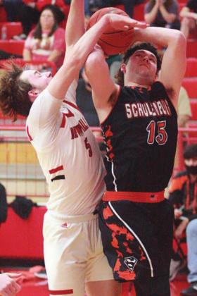 Brett Janecek gets fouled on a drive to the basket early in the third quarter. Sticker Photo By Darrell Vyvjala