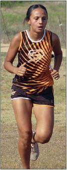 Yasmin Cortez strides up the final stretch of her second lap to finish 31st. Sticker Photo By Darrell Vyvjala